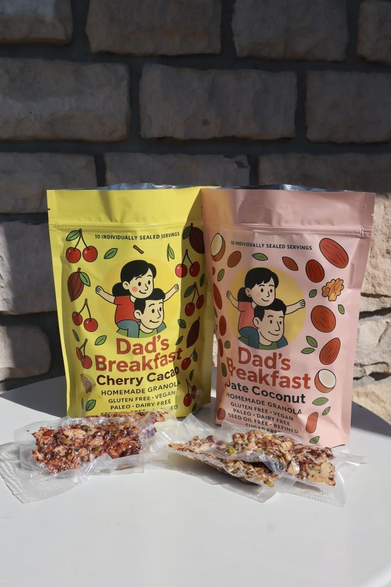 Dad's Breakfast Date Coconut and Cherry Cacao granola bags with individually air-sealed servings